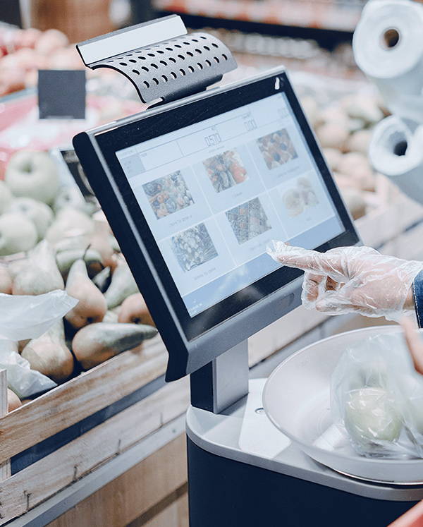 In the supermarket, a customer is touching on POS system