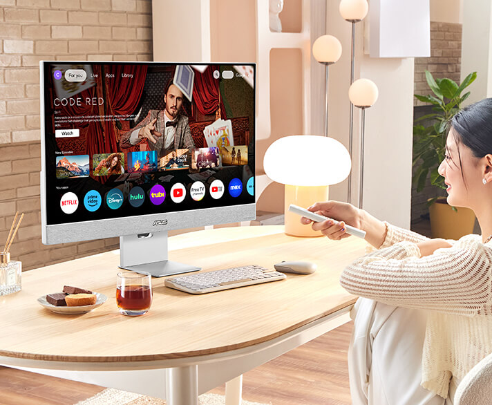 A young female professional enjoy various entertainment content on Google TV with the ASUS ZenScreen Smart Monitor MS27UC in her small living space