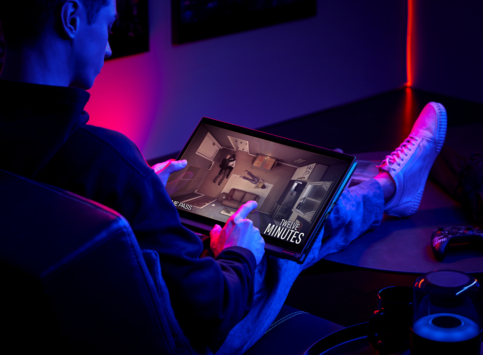 Gamer playing a game with the Flow X16 in their lap in tablet mode.