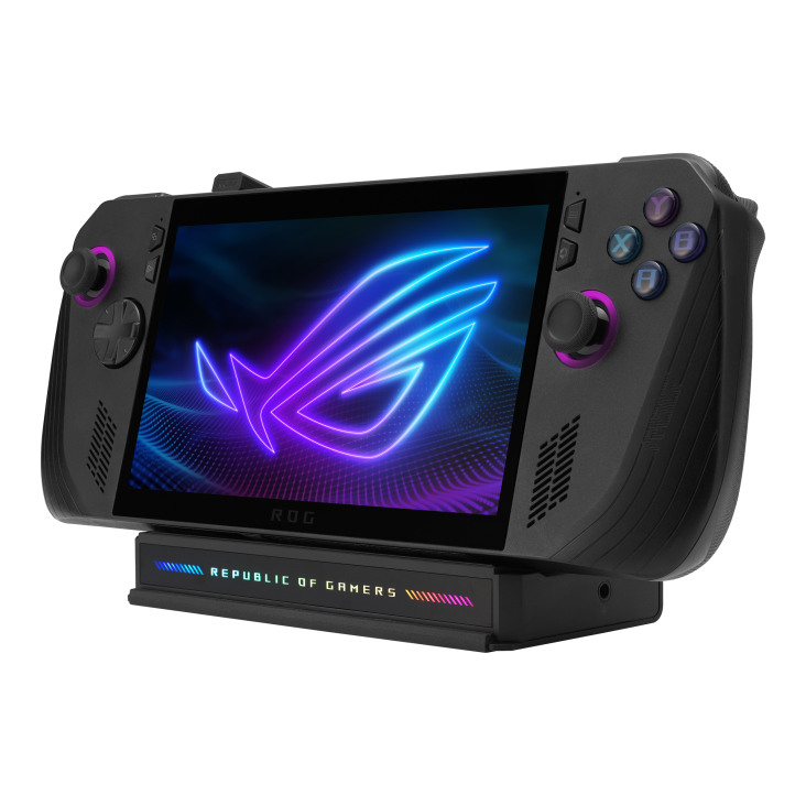ROG Ally handheld gaming device docked on a black charging station with rainbow lighting