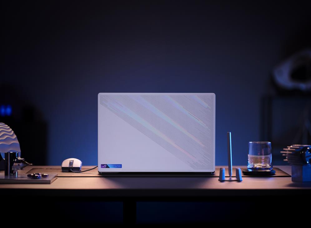 Rear view of a white Zephyrus G15 with a white mouse attached on a table.