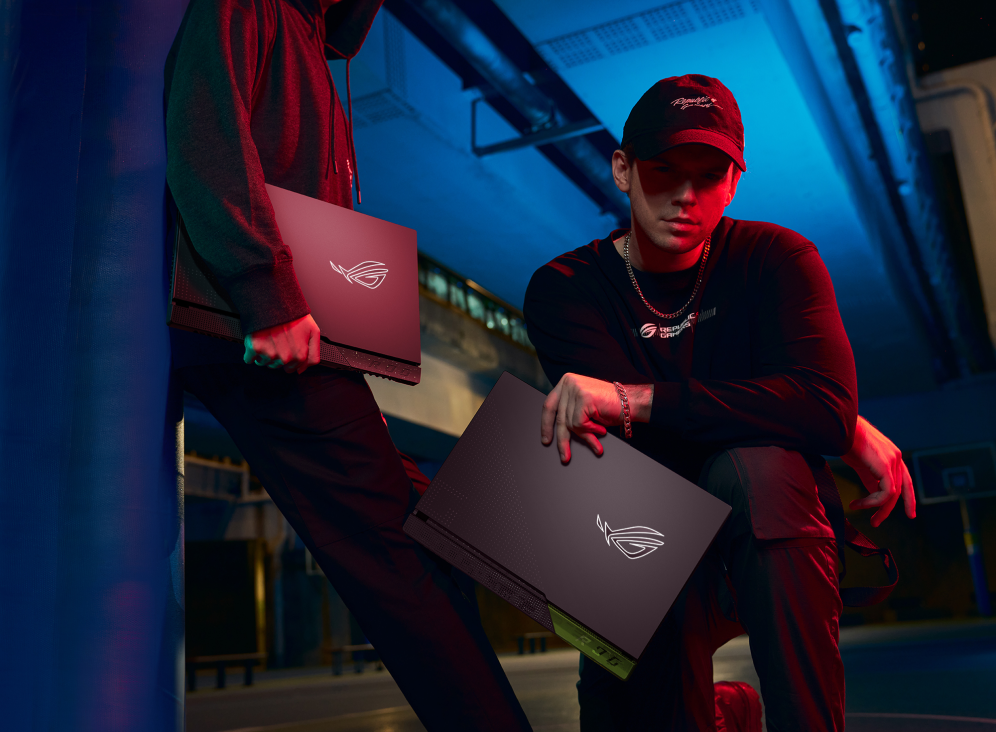 Two people at night on a basketball court, both holding a Strix G17.