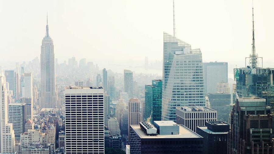 Cityscape with skyscrapers under hazy sky, symbolizing smart city innovation and urban IoT development