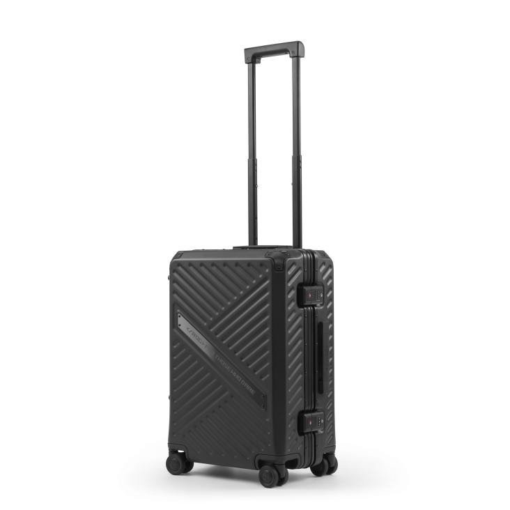 SLASH Hardcase Luggage on a white background, sitting its wheels with the luggage handle fully extended
