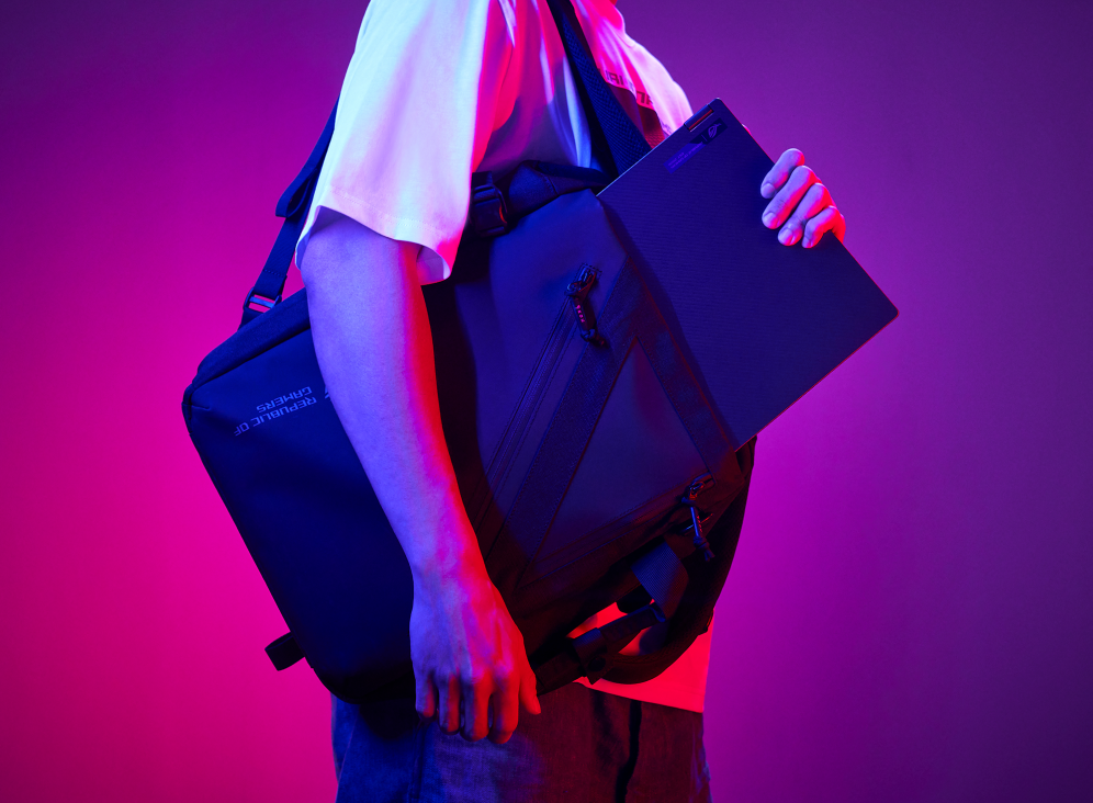 Person slipping a Flow X16 into an ROG backpack.