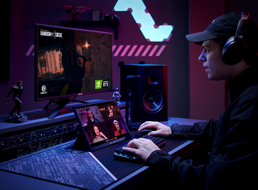 Man using a Flow Z13 with kickstand extended, playing a game with an external monitor, mouse and keyboard, with a video call on the Flow Z13's screen.