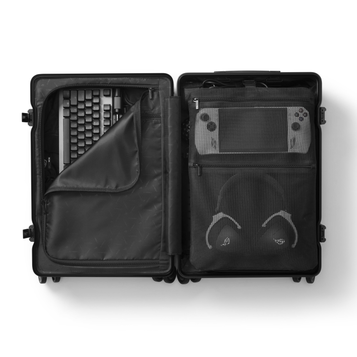 SLASH Hardcase Luggage on a white background, with the bag opened and computer accessories inside