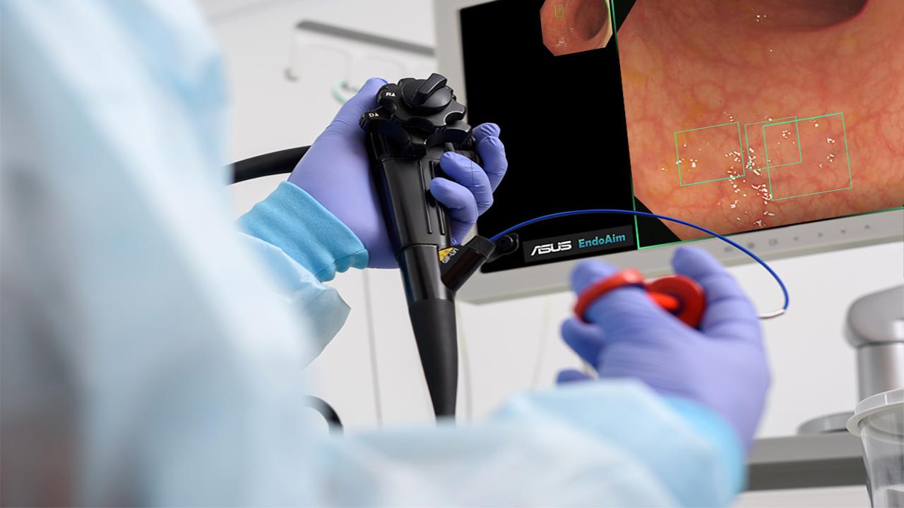 A medical professional in blue gloves uses ASUS EndoAim Endoscopy AI, with a monitor showing internal images. The setting conveys focus and precision.