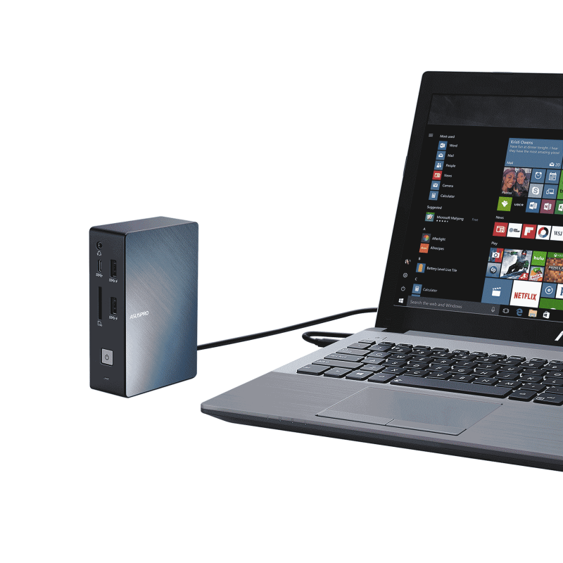 An angled front view of an ASUS SimPro Dock placed next to an ASUS laptop